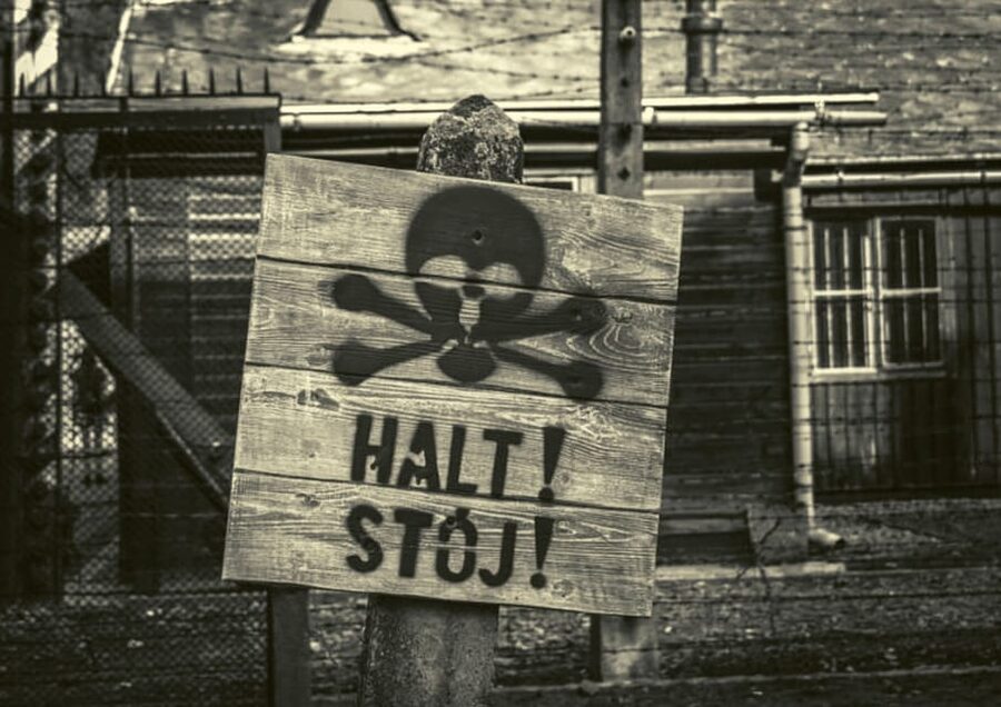 From Warsaw: Auschwitz Day Tour by Private Car with Lunch - Entering Auschwitz through the Arbeit Macht Frei gate