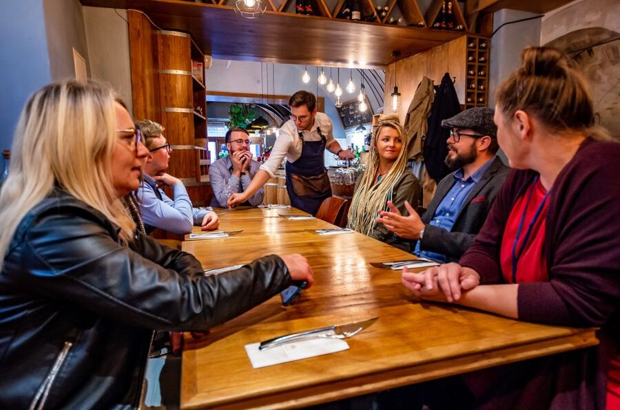 Krakow: Guided Wine Bar Tour with Tastings and Snacks - Walking through Krakow Old Town between glasses