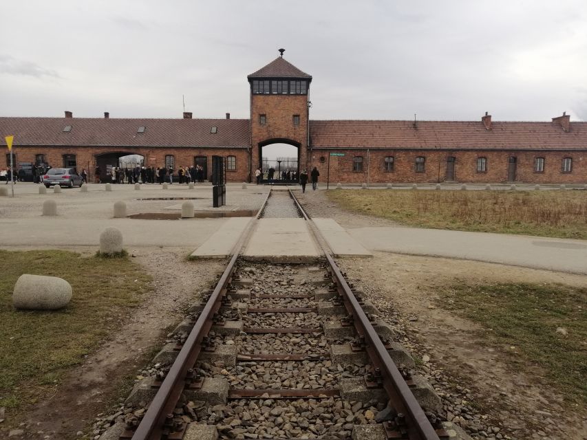 Warsaw: Auschwitz-Birkenau and Krakow Tour by Car - Entering Auschwitz I with a museum guide